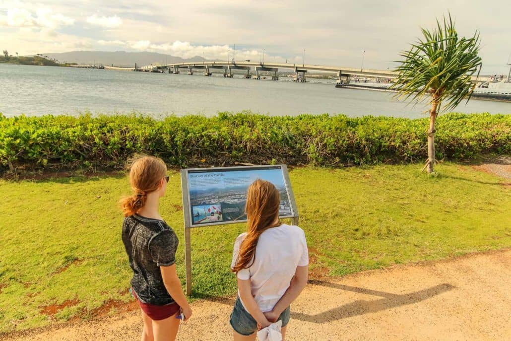 Women Reading Poster Board at National Monument