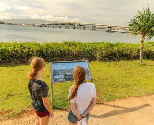 Women Reading Poster Board at National Monument