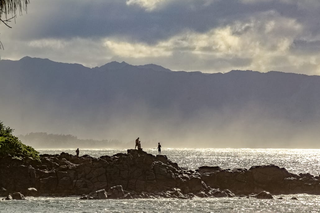 North Shore Rocks and People with Wave Spray Oahu