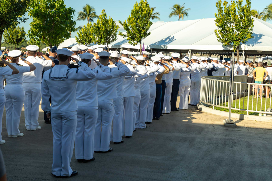 Pearl Harbor Day Sailors salute survivors exiting ceremony tent Oahu