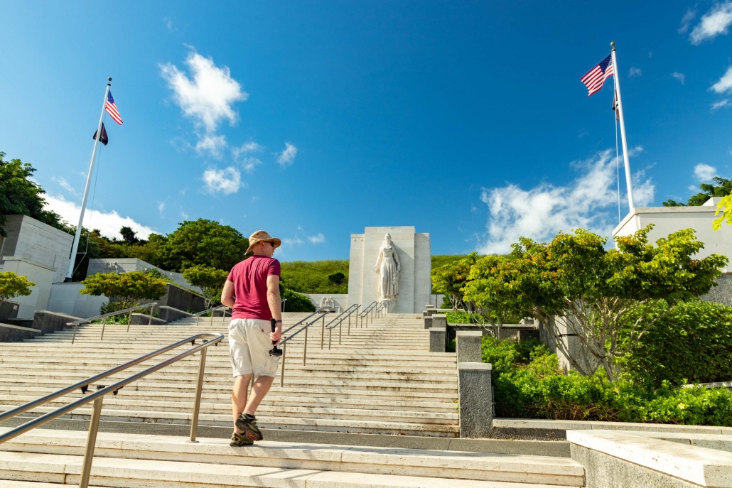 A visitor climbs the steps of Honolulu Memorial at Punchbowl Cemetery