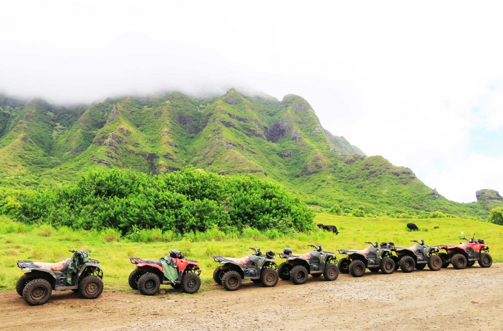 kualoa-atvs-in-a-row-on-the-off-road-with-mountain-and-medow-background