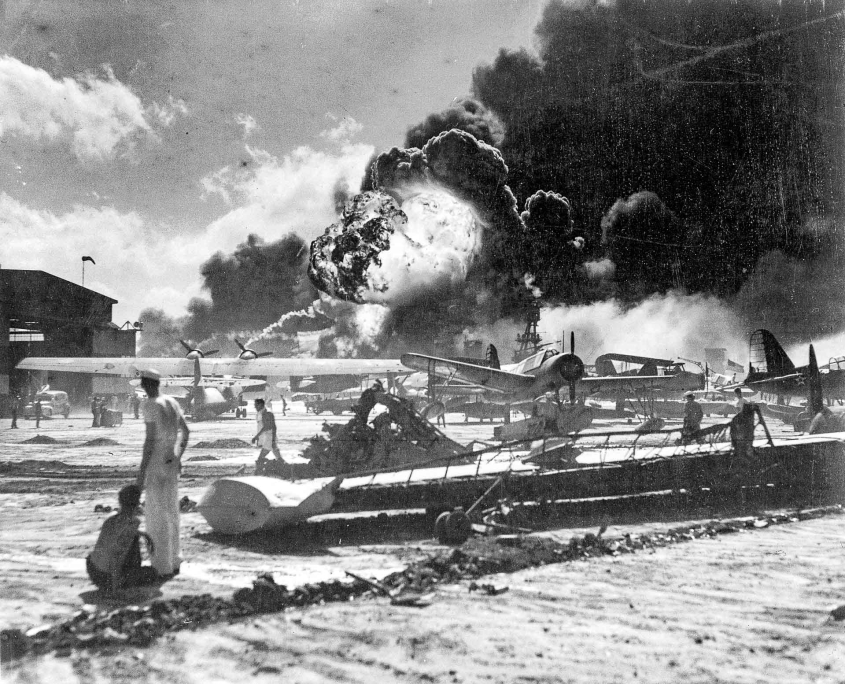 Ford Island Seaplane Base Burning USS Shaw exploding in background Dec7 1941 US Navy photo wikimedia